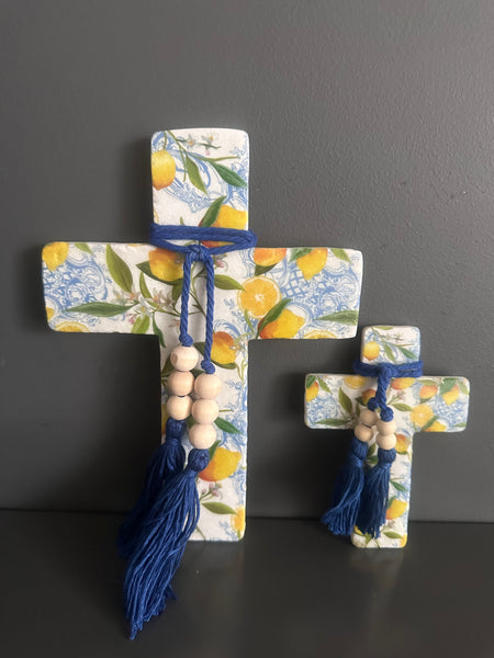 Decorative cross with floral and lemon pattern on a dark background