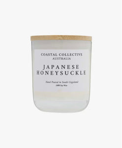 White Jar Soy Candle with a wooden lid labeled 'Coastal Collective Australia Japanese Honeysuckle' on a white background