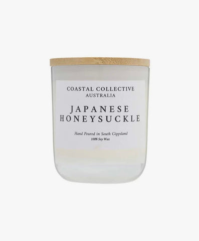 White Jar Soy Candle with a wooden lid labeled 'Coastal Collective Australia Japanese Honeysuckle' on a white background