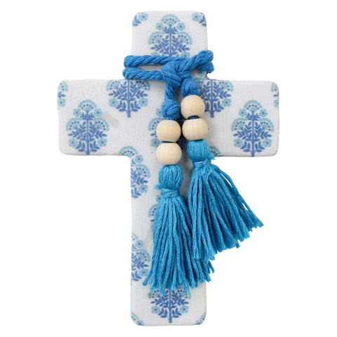 Decorative cross with blue tassels and beads on a white background