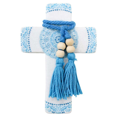 Decorative cross with blue patterns and tassels on a white background